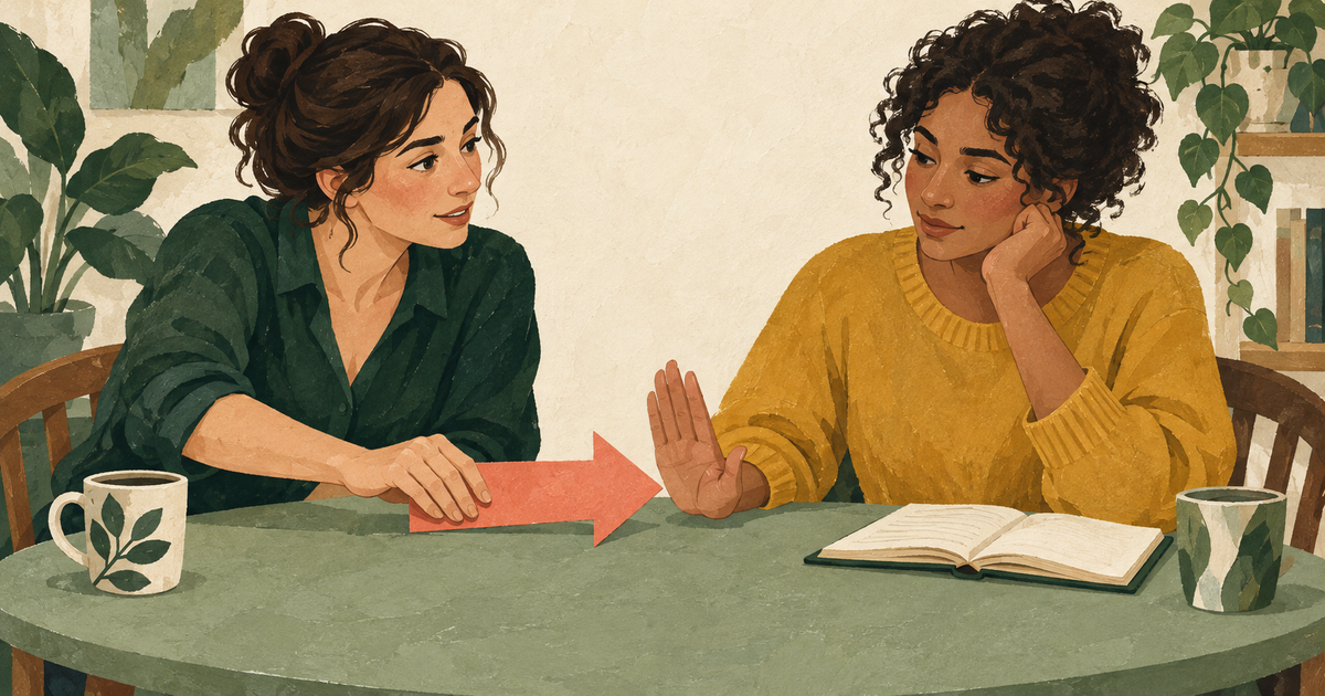 One friend offers a coral paper arrow across a table while the other raises a hand to pause it beside an open journal.